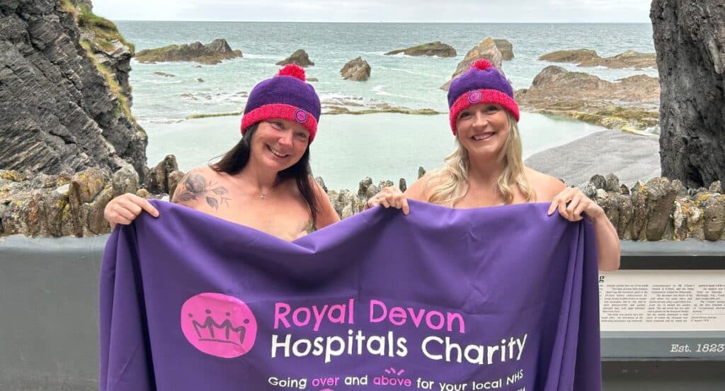 Louise Butcher – aka the Topless Runner – and Royal Devon Hospitals Charity community fundraiser Kate Constable at Tunnels Beach in Ilfracombe. Pic: RDHC