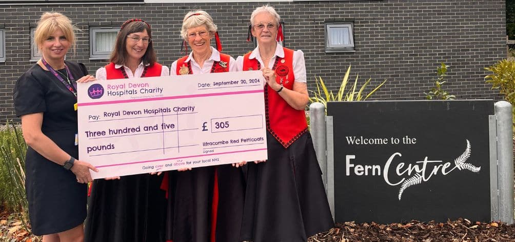 Members of The Ilfracombe Red Petticoats present the groups’ fundraising cheque to Fern Centre manager Tara Jones. Pic: Royal Devon Hospitals Charity